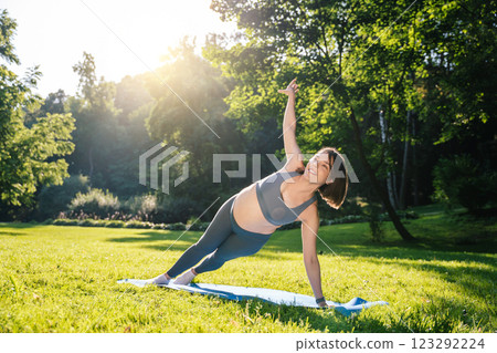 Young pregnant woman on third trimester exercising in the park Young pregnant woman on third trimester exercising in the park 123292224
