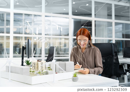Ginger young woman working in the modern office 123292309
