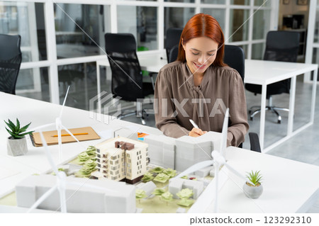Ginger young woman working in the modern office 123292310