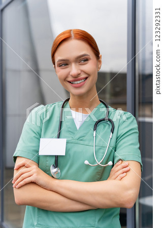 Redhead woman doctor standing in modern office in hospital 123292331