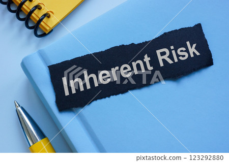 Notebook labeled Inherent Risk. Financial uncertainty. 123292880