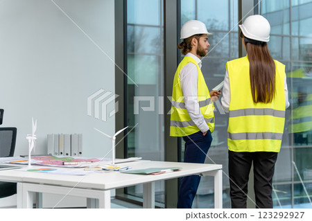 Two engineers working in the office on a new green energy project 123292927