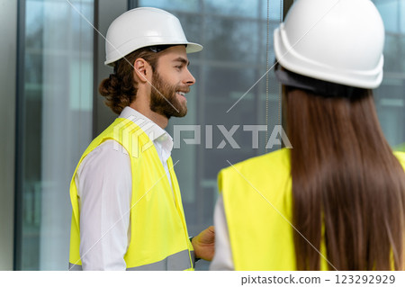 Two engineers working in the office on a new green energy project Two engineers working in the office on a new green energy project 123292929