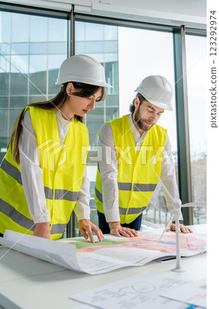 Colleagues engineers discussing and planning steps for a new project Colleagues engineers discussing and planning steps for a new project 123292974
