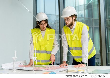 Colleagues engineers discussing and planning steps for a new project Colleagues engineers discussing and planning steps for a new project 123292978