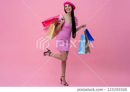 Pretty happy young woman in pink after shopping Pretty happy young woman in pink after shopping 123293508