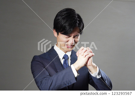 Businessman pleading black background 123293567