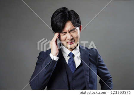 Businessman headache black background Businessman headache black background 123293575