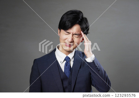 Businessman headache black background Businessman headache black background 123293576