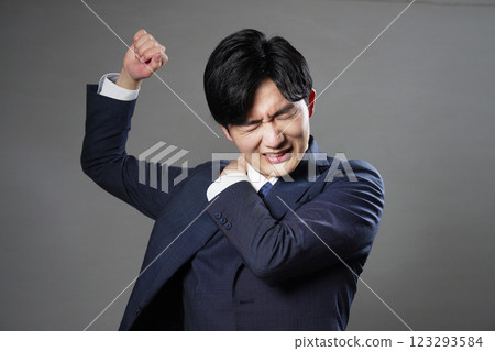 Businessman stiff shoulders black background Businessman stiff shoulders black background 123293584