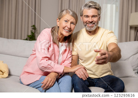 Mature happy couple spending time at home and looking excited Mature happy couple spending time at home and looking excited 123293616