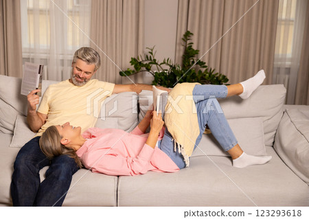 Mature happy couple spending time at home and looking excited Mature happy couple spending time at home and looking excited 123293618