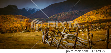 Rustic wooden fence in scenic autumn mountain landscape under misty skies 123293898