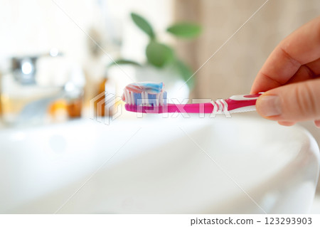 Toothpaste on a toothbrush contains natural salt, helps remove plaque, and strengthens gums. Free from fluoride and artificial additives. Toothpaste on a toothbrush contains natural salt, helps remove plaque, and strengthens gums. Free from fluoride and artificial additives. 123293903