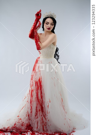 Bridal beauty in bloodstained gown with knife in dramatic setting Bridal beauty in bloodstained gown with knife in dramatic setting 123294335