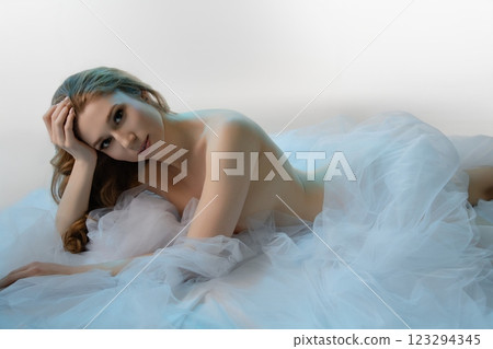 Elegant woman in sensual lingerie with soft tulle fabric indoors 123294345