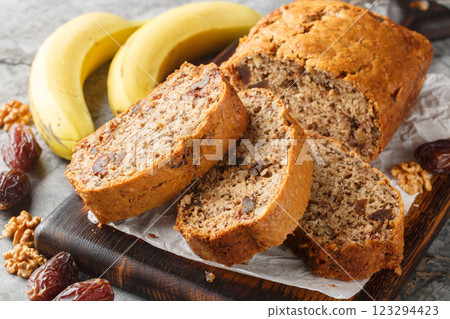 banana walnut date loaf is a flavorful and healthy bread featuring honey, olive oil and warming spices closeup on the wooden board. Horizontal banana walnut date loaf is a flavorful and healthy bread featuring honey, olive oil and warming spices closeup on the wooden board. Horizontal 123294423