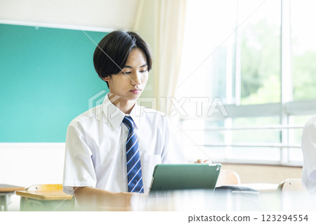 High school boy studying on a tablet High school boy studying on a tablet 123294554