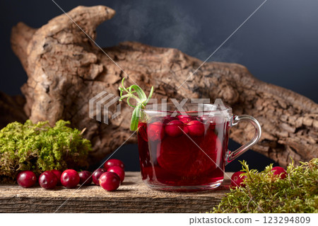 Hot drink with cranberries, lime, and rosemary on a old wooden board. Hot drink with cranberries, lime, and rosemary on a old wooden board. 123294809