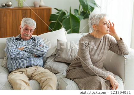 Marriage crisis relationship problems. Old couple quarreling. Sad mature disappointed woman sitting away from husband after having quarrel. Senior couple not talking having problems in relationship Marriage crisis relationship problems. Old couple quarreling. Sad mature disappointed woman sitting away from husband after having quarrel. Senior couple not talking having problems in relationship 123294951