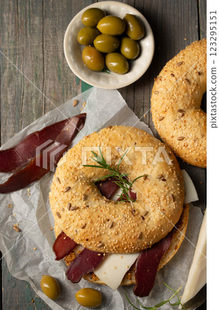 Burger with basturma, olives and rosemary, top view Burger with basturma, olives and rosemary, top view 123295151
