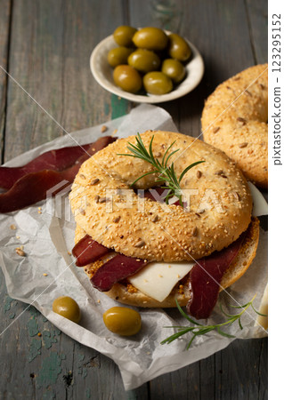 Burger with basturma, olives and rosemary Burger with basturma, olives and rosemary 123295152