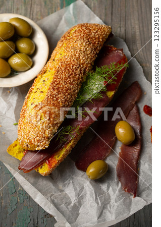 Burger with ciabatta with turmeric and bastrum, top view Burger with ciabatta with turmeric and bastrum, top view 123295156