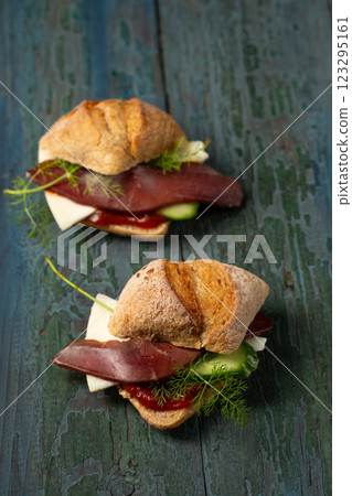 Two small sandwiches with basturma, herbs and cucumber Two small sandwiches with basturma, herbs and cucumber 123295161