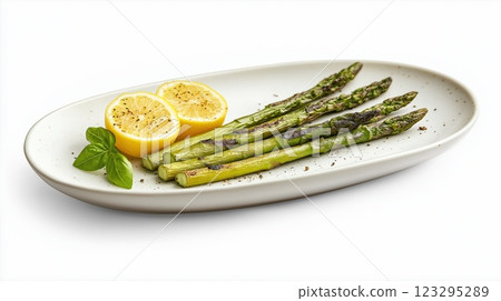 Grilled asparagus spears served with lemon halves 123295289
