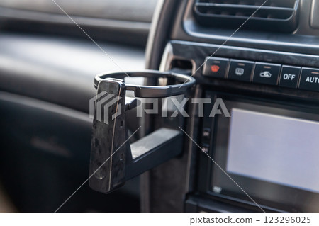 Interior view with cupholder on front dashboard in the car. Interior view with cupholder on front dashboard in the car. 123296025