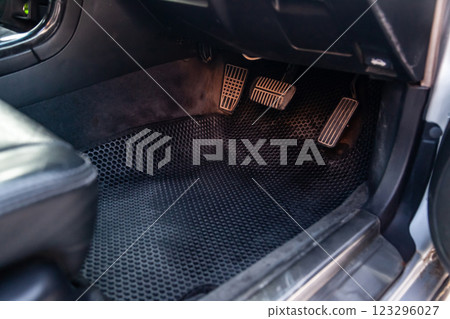 Close-up of a clean black rubber auto mat under a passenger seat in an old Russian car after dry cleaning. 123296027