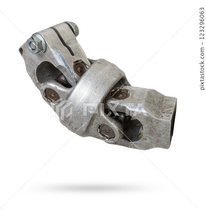 The spare part of the car is a metal steering propeller shaft with hinges on a white background with inscriptions designating the model. Repair of equipment at the auto-parsing in the workshop. 123296063