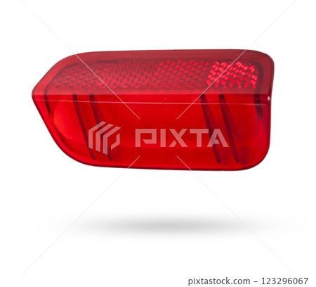 A transparent plastic red shade for illuminating the interior on a white isolated background in a photo studio - spare parts for repairing a car interior or for sale in a auto service. A transparent plastic red shade for illuminating the interior on a white isolated background in a photo studio - spare parts for repairing a car interior or for sale in a auto service. 123296067