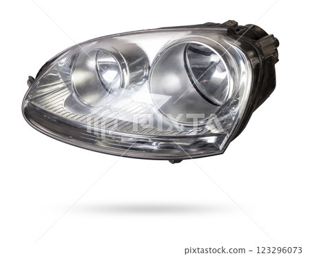 Stylish xenon headlight of a German car - optical equipment with a lamp inside on a white isolated background. Spare part for auto repair in a car workshop. 123296073