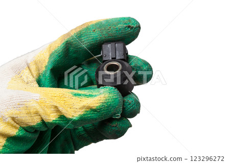 Knock sensor for vehicle engines spare parts electrical parts sensors in arm with glove on white background copy space Knock sensor for vehicle engines spare parts electrical parts sensors in arm with glove on white background copy space 123296272