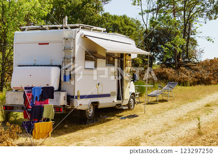 Clothes hanging to dry outdoors by camping car. Caravan vacation. 123297250