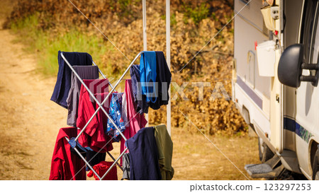 Clothes hanging to dry outdoors by camping car. Caravan vacation. 123297253