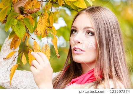 woman fashion girl relaxing walking in autumnal park woman fashion girl relaxing walking in autumnal park 123297274
