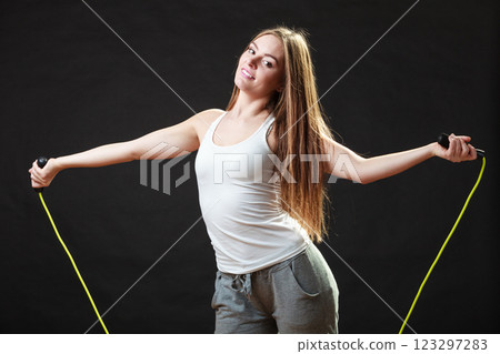 Fit woman with jumping rope 123297283