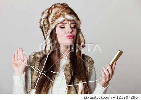 Winter girl enjoying music. Winter girl enjoying music. 123297286