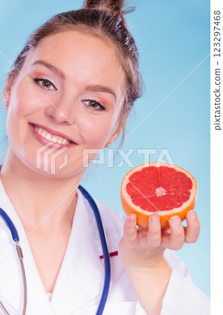 Happy dietitian nutritionist with grapefruit. Happy dietitian nutritionist with grapefruit. 123297468