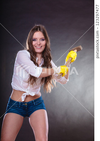 Sexy alluring woman holding hammer. Feminism. Sexy alluring woman holding hammer. Feminism. 123297477