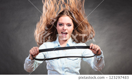 Sexy alluring woman holding fan belt. Feminism. Sexy alluring woman holding fan belt. Feminism. 123297483