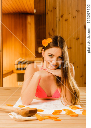 Young woman relaxing in sauna. Spa wellbeing. 123297502