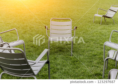 Metallic chairs standing on grass 123297687