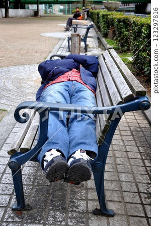Senior man lying on a bench Senior man lying on a bench 123297816