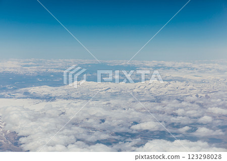 Mountain view with clouds from flying plane Mountain view with clouds from flying plane 123298028