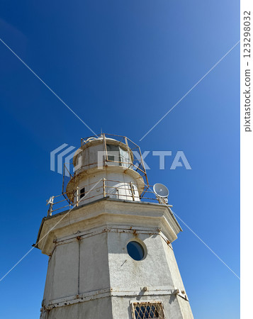 Coastal Lighthouse for Navigation on Blue Sky Background 123298032
