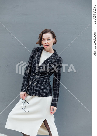 woman 40 years old in business suit on gray background woman 40 years old in business suit on gray background 123298253