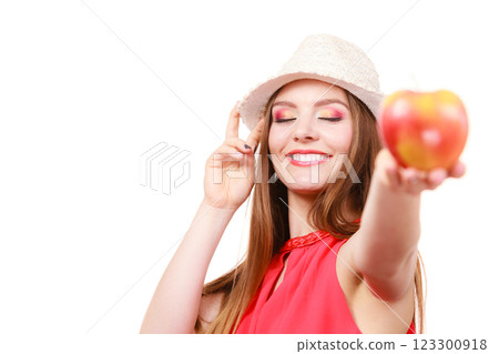 Woman summer hat colorful makeup holds apple fruit Woman summer hat colorful makeup holds apple fruit 123300918